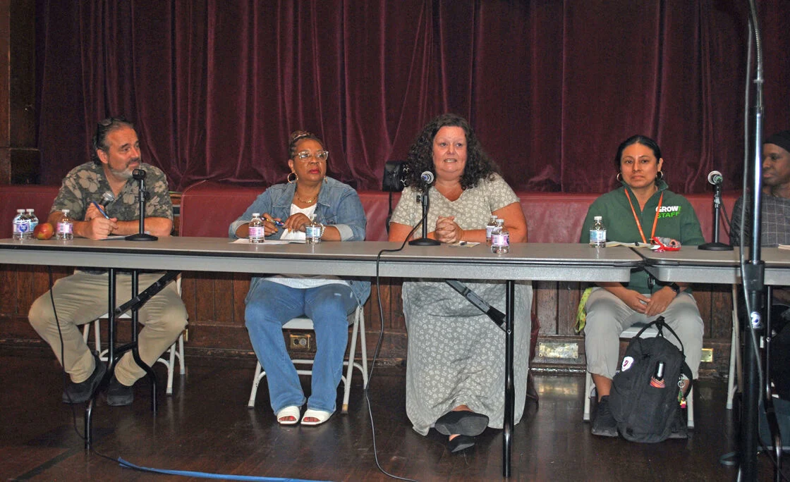 Food pantries dealing with post Covid reality Group of people sitting at a table during a panel discussion.